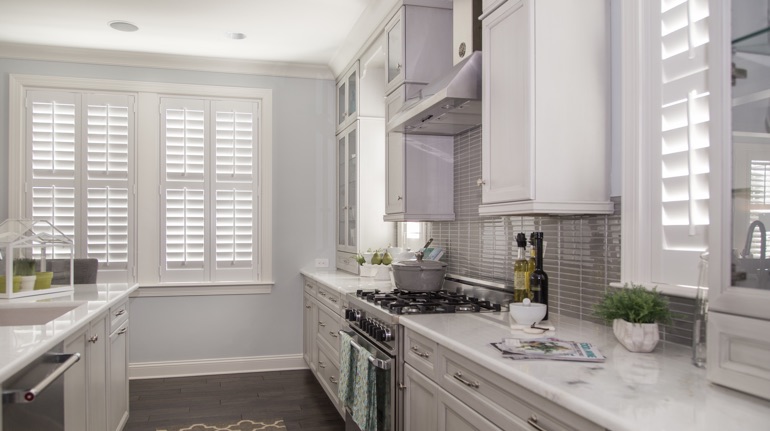 Plantation shutters in Boston kitchen with marble counter.
